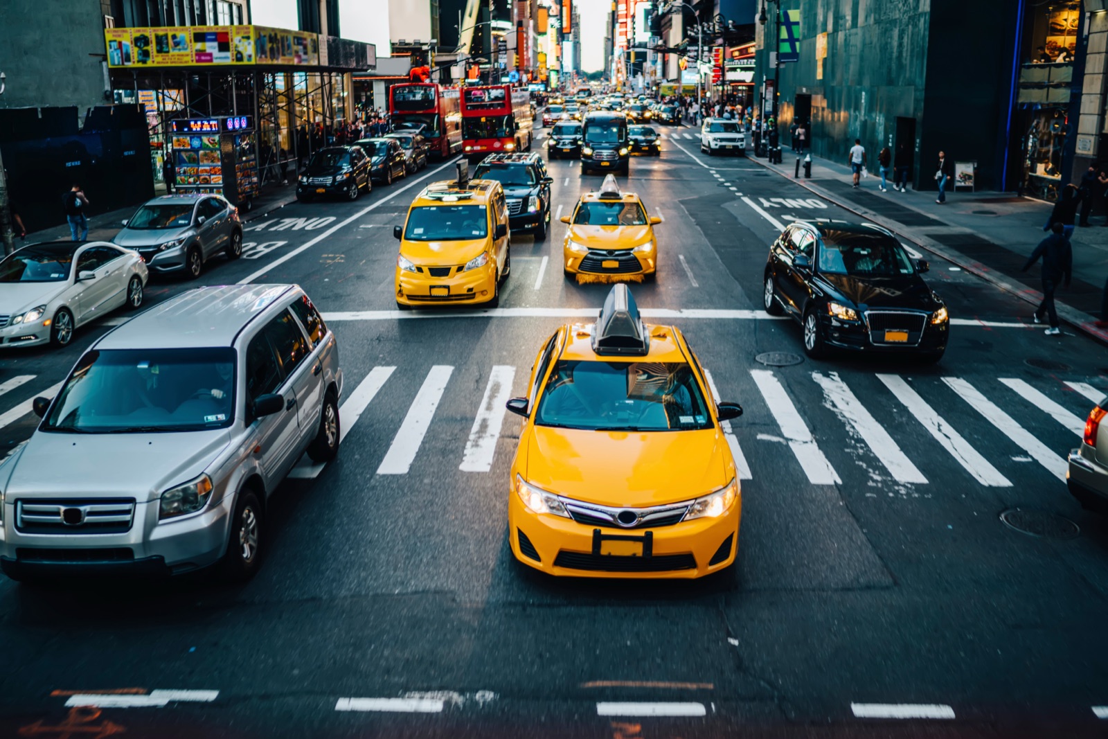 Yellow cabs threading through Manhattan traffic.